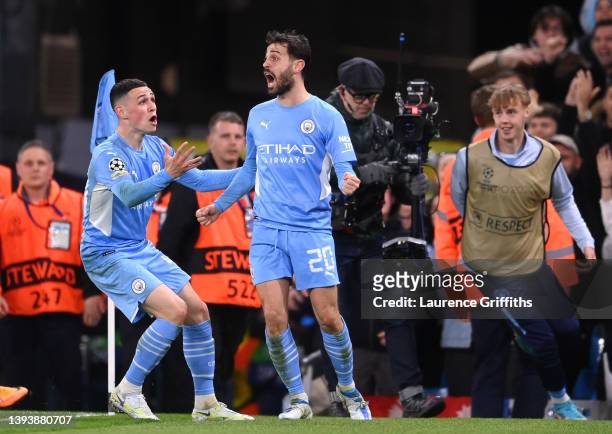 Bernardo Silva of Manchester City celebrates with teammate Phil Foden after scoring their side's fourth goal during the UEFA Champions League Semi...