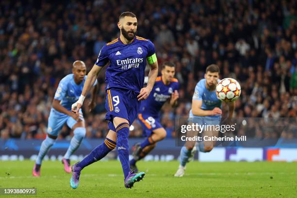 Karim Benzema of Real Madrid scores their side's third goal from the penalty spot during the UEFA Champions League Semi Final Leg One match between...
