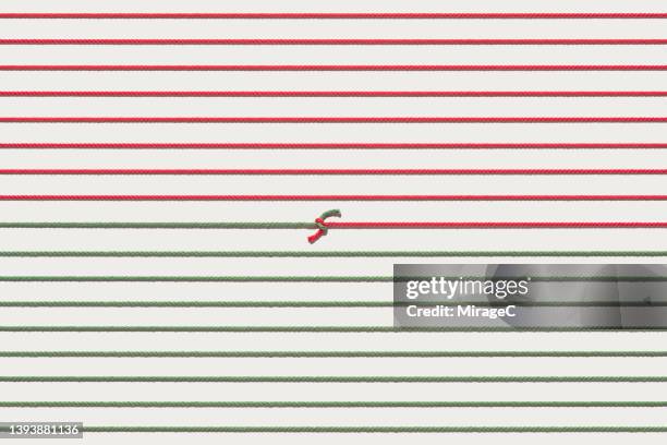 red and green colored straightened ropes tied and connected together - string stock pictures, royalty-free photos & images
