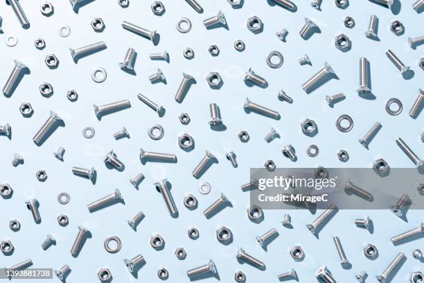 screws and nuts on blue full frame pattern - bult bildbanksfoton och bilder