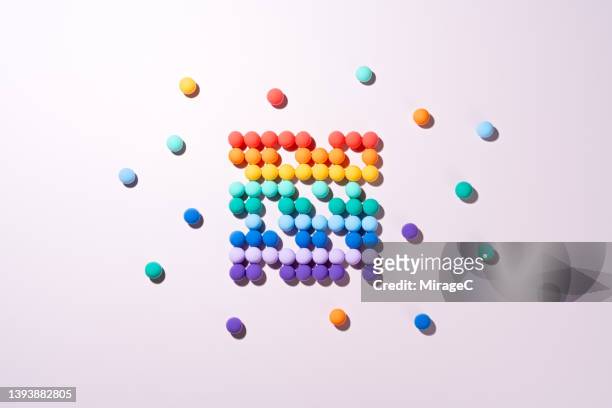 rainbow colored spheres converging together by color - separation concept stock pictures, royalty-free photos & images
