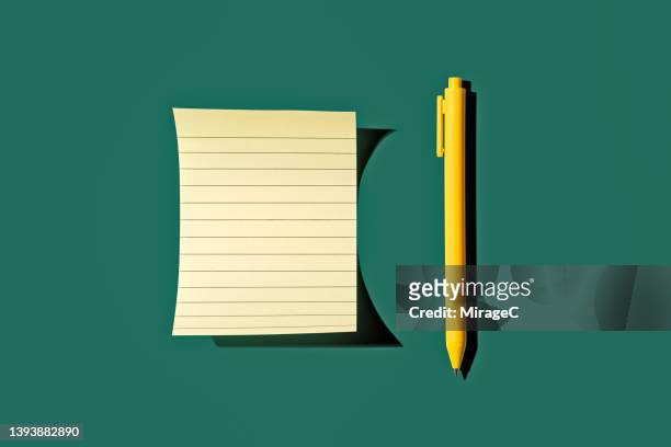 yellow pen and memo paper sheet - ballpoint pen stock pictures, royalty-free photos & images