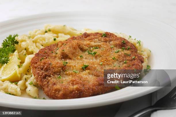german pork schnitzel with hand made spaetzle - fried dough stock pictures, royalty-free photos & images