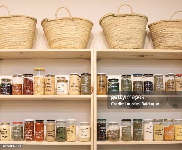 shelves with a selection of food in glass jars - food pantry stockfoto's en -beelden