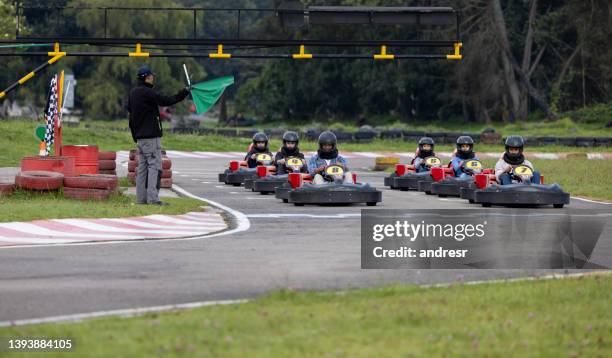 group of racers at the starting line of a go-cart track - go cart stock pictures, royalty-free photos & images