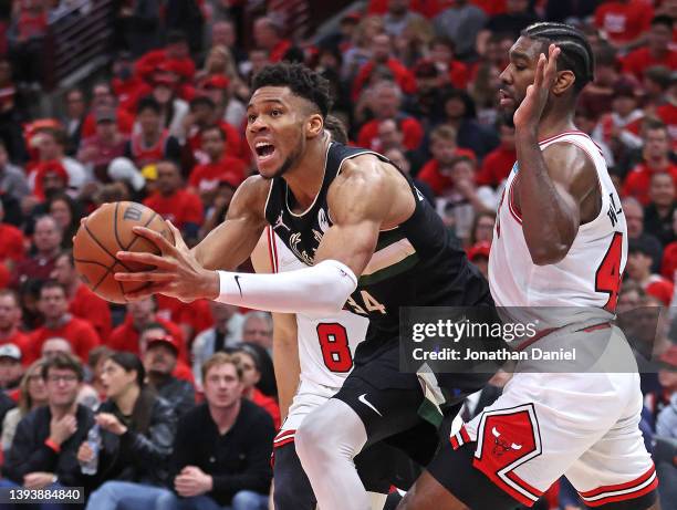 Giannis Antetokounmpo of the Milwaukee Bucks drives between Zach LaVine and Patrick Williams of the Chicago Bulls during Game Four of the Eastern...