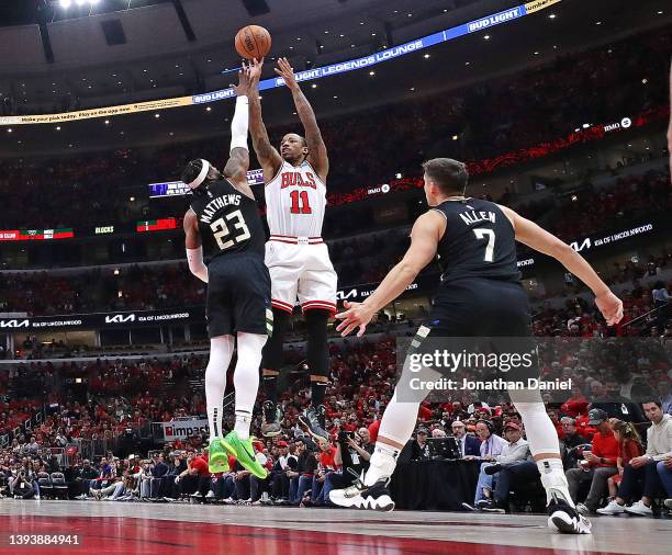 DeMar DeRozan of the Chicago Bulls shoots over Wesley Matthews and Grayson Allen of the Milwaukee Bucks during Game Four of the Eastern Conference...