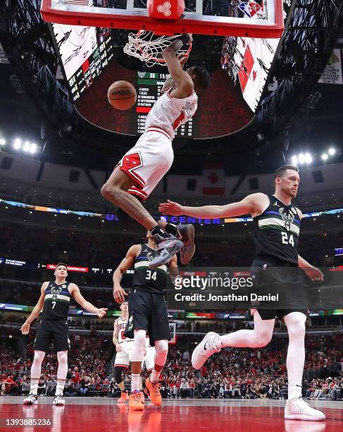 Derrick Jones Jr. #5 of the Chicago Bulls dunks over Pat Connaughton and Giannis Antetokounmpo of the Milwaukee Bucks during Game Four of the Eastern...