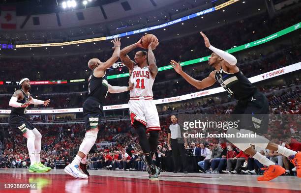 DeMar DeRozan of the Chicago Bulls looks to pass against Wesley Matthews, Jevon Carter and Giannis Antetokounmpo of the Milwaukee Bucks during Game...