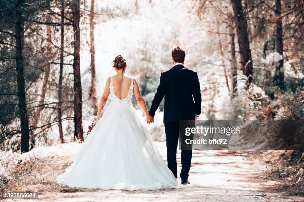 wedding couple posing in forest. - couple dark background stock pictures, royalty-free photos & images