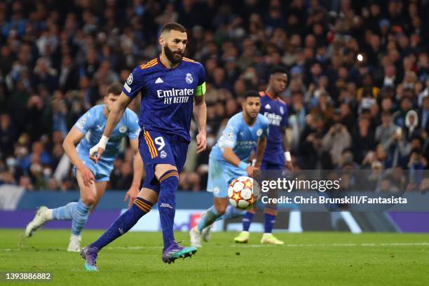 Karim Benzema of Real Madrid scores his side's third goal from the penalty spot during the UEFA Champions League Semi Final Leg One match between...