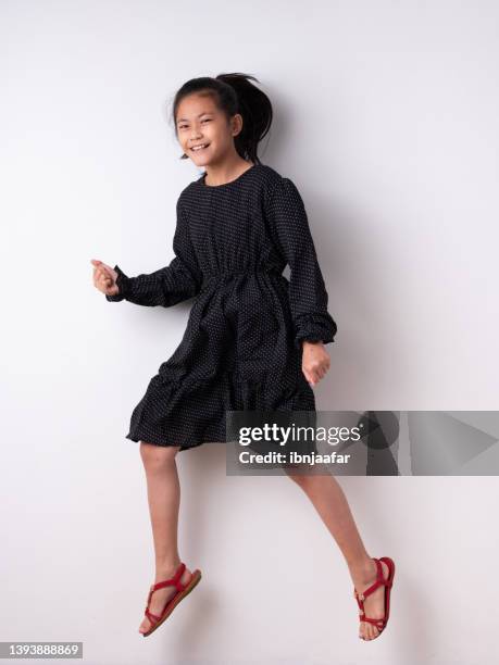 energetic jumping kids in studio - young girl white background stock pictures, royalty-free photos & images