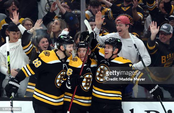 Taylor Hall of the Boston Bruins celebrates with Erik Haula and Derek Forbort after scoring a goal against the Florida Panthers during the first...