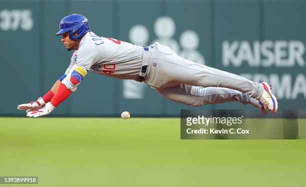 Willson Contreras of the Chicago Cubs dives for second base on a double to lead off the second inning against the Atlanta Braves at Truist Park on...