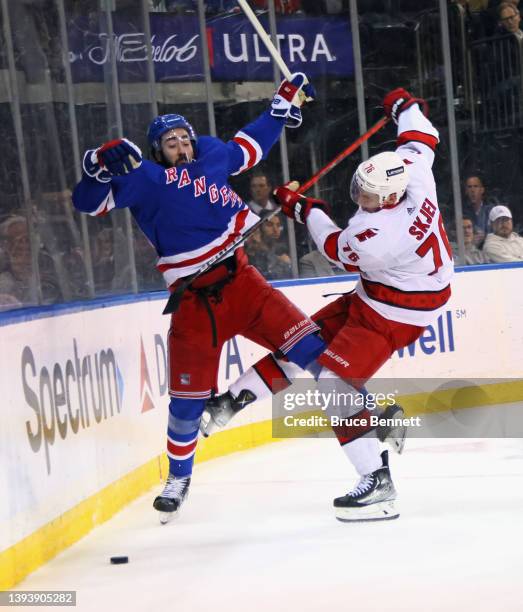 Mika Zibanejad of the New York Rangers and Brady Skjei of the Carolina Hurricanes collide during the second period at Madison Square Garden on April...