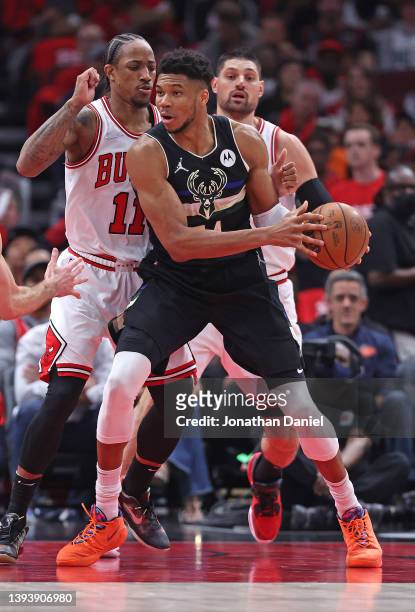 DeMar DeRozan and Nikola Vucevic of the Chicago Bulls defend against Giannis Antetokounmpo of the Milwaukee Bucks during Game Four of the Eastern...