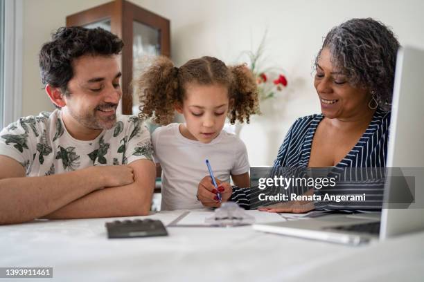 family teaching finances to child - grandma invoice bildbanksfoton och bilder