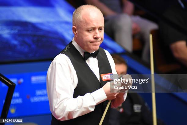 John Higgins of Scotland chalks the cue during the quarter-final match against Jack Lisowski of England on day 11 of the Betfred World Snooker...