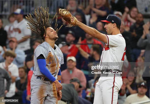 Matt Olson of the Atlanta Braves reacts after tagging out Michael Hermosillo of the Chicago Cubs at first base on a double play in the eighth inning...