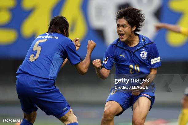 Daisuke Takahashi of Oita Trinita celebrates scoring his side's first goal with his team mate Edmilson during the J.League J1 match between Oita...