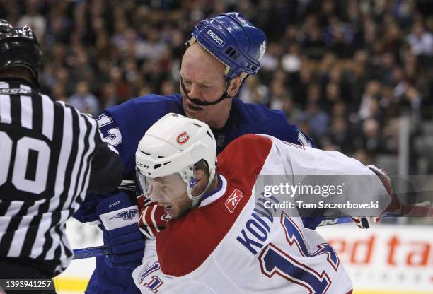 Mats Sundin of the Toronto Maple Leafs has his helmet knocked loose as he faces-off against Saku Koivu of the Montreal Canadiens during NHL game...