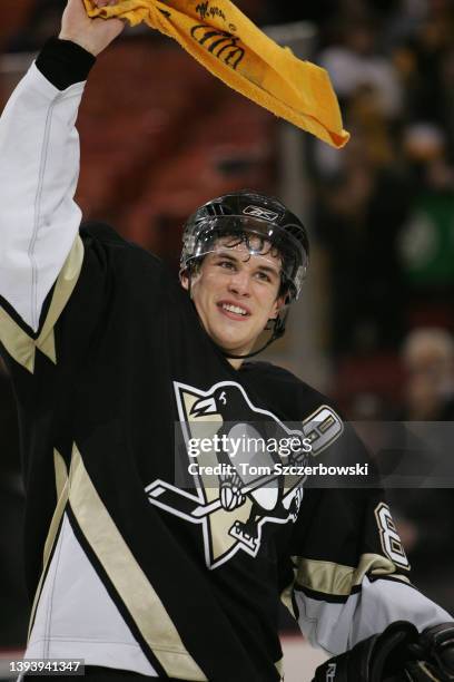 Sidney Crosby of the Pittsburgh Penguins waves a Steelers Terrible Towel after being named the first star of the game in their 8-1 win against the...