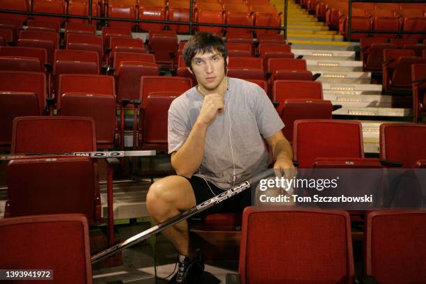 Alex Ovechkin of the Washington Capitals tapes his stick as he sits in the stands before the start of their NHL game against the Pittsburgh Penguins...