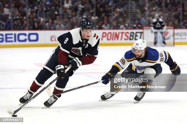 Cale Makar of the Colorado Avalanche advances the puck against Nathan Walker of the St Louis Blues in the second period at Ball Arena on April 26,...