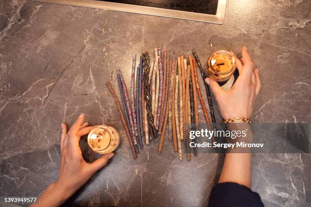 faceless woman at table with scented candles - mist diffuser stock pictures, royalty-free photos & images