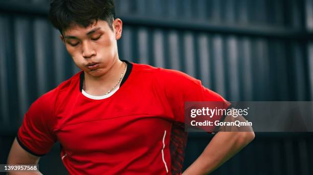 《badminton spirit》resting and panting after jumping smash - frustrated stock pictures, royalty-free photos & images