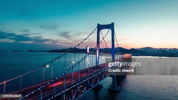 cross-sea bridge at night - cable stayed bridge stock pictures, royalty-free photos & images