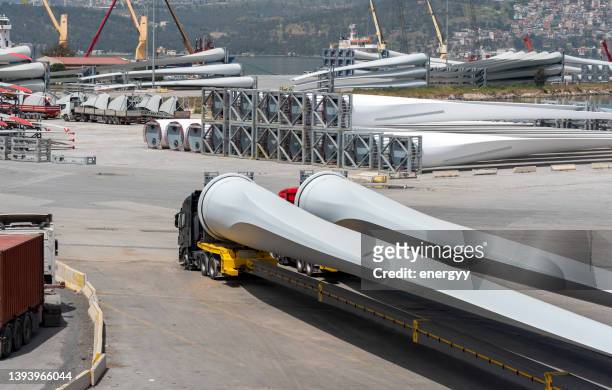 wind turbine blades waiting to be transported at the port - freight truck loading stock pictures, royalty-free photos & images