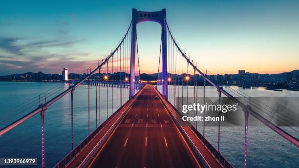 cross-sea bridge at night - 橋 ストックフォトと画像