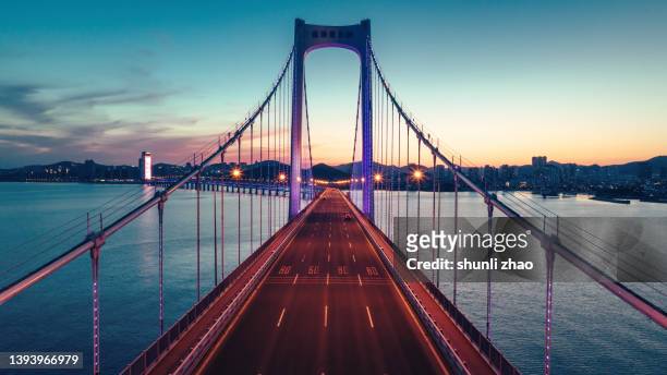 cross-sea bridge at night - distant stock pictures, royalty-free photos & images