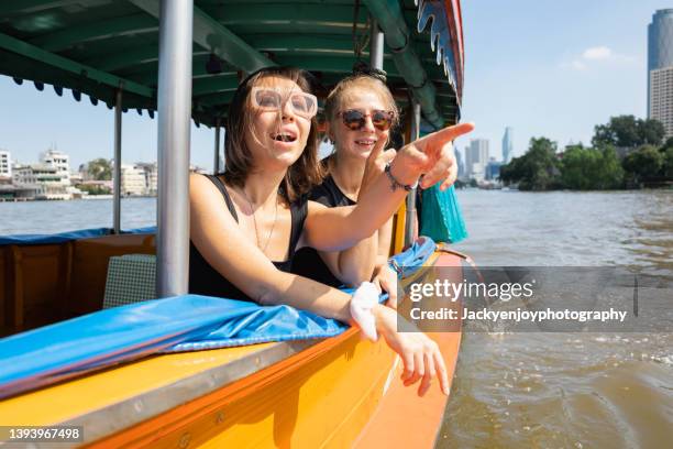 lady enjoy boat travel in bangkok - ferry passenger stock pictures, royalty-free photos & images