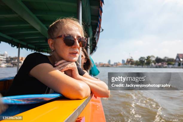 lady enjoy boat travel in bangkok - båttaxi bildbanksfoton och bilder