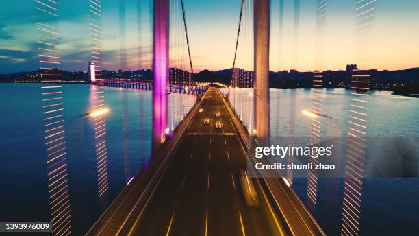 cross-sea bridge at night - connected city stock-fotos und bilder