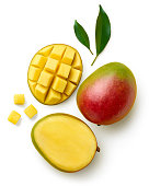 Fresh whole half and sliced mango fruit and leaves