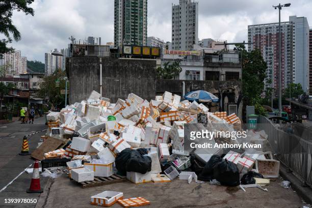 Empty styrofoam containers pile up on the side of a street at a wet market on April 26, 2022 in Hong Kong, China. Styrofoam containers used to bring...