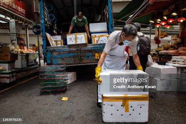 Workers unload styrofoam containers of fresh foodat a wet market on April 27, 2022 in Hong Kong, China. Styrofoam containers used to bring in fresh...