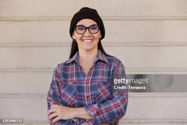 a middle-aged hipster woman is posing for the camera. - skogshuggarskjorta bildbanksfoton och bilder