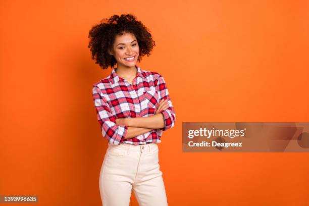 Photo of millennial curly lady crossed palms wear plaid shirt isolated on orange color background