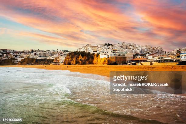 dramatic view of old town and beach in albufeira, algarve, portugal - albufeira stock pictures, royalty-free photos & images