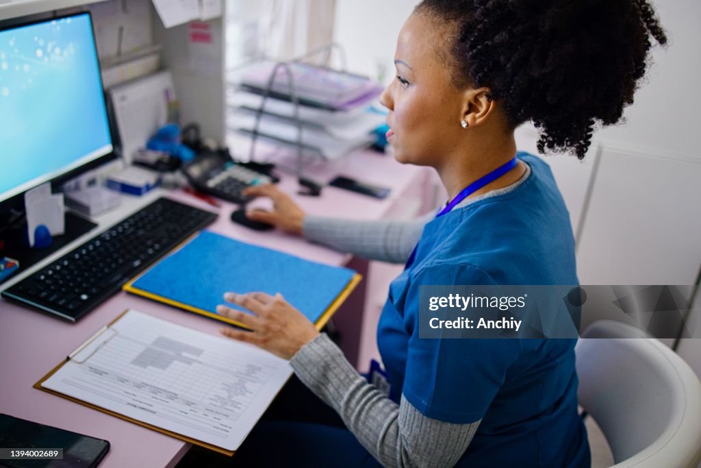 Nurse working at the reception desk in the private clinic