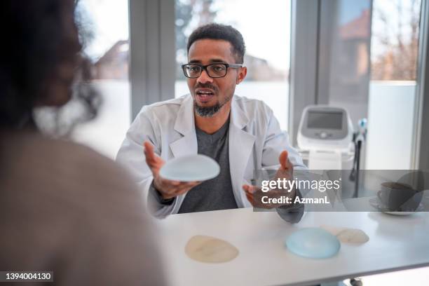 doctor holding a silicon implant - plastic surgeon stock pictures, royalty-free photos & images