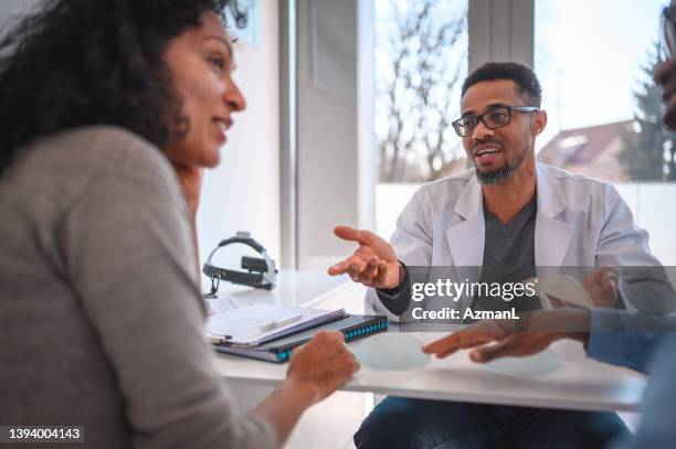 african american surgeon with a client - plastic surgeon stock pictures, royalty-free photos & images