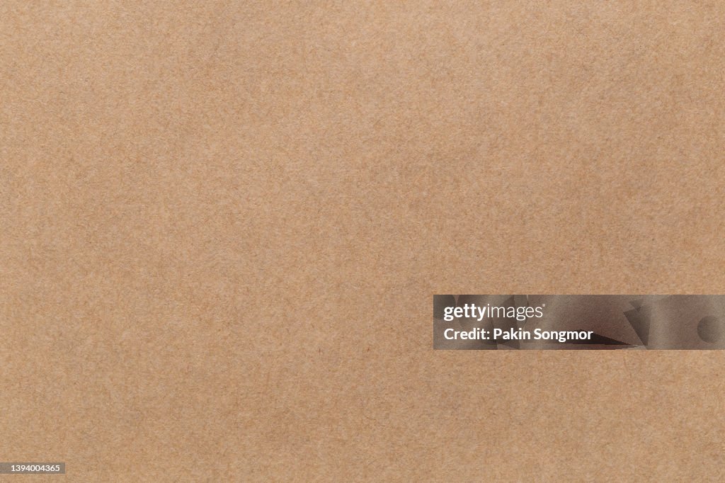 Brown color eco recycled kraft paper sheet texture cardboard background.