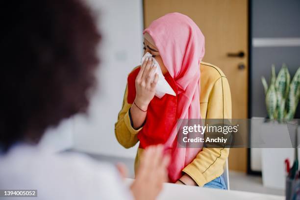 a muslim woman cries in a gynecologist's office due to bad health results - hpv stock pictures, royalty-free photos & images