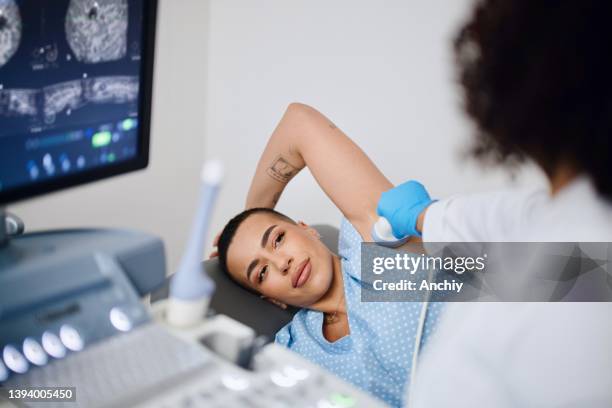 the radiologist doing an ultrasound-guided breast biopsy. - chest stock pictures, royalty-free photos & images