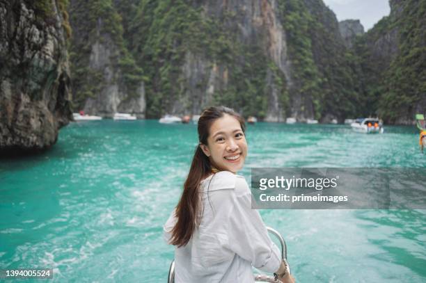 happy travel staycation wanderlust asian young asian tourism on moving boat relaxing at island  krabi province, thailand south east asia - phi phi island stock pictures, royalty-free photos & images